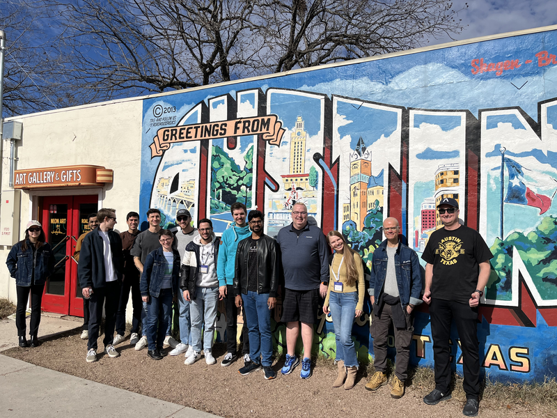 Group photo of diverse individuals in casual clothing.